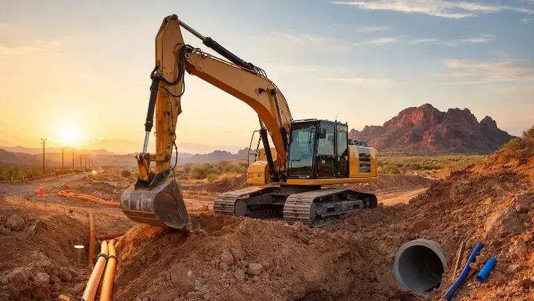 Excavator performing site development and rough grading in Arizona